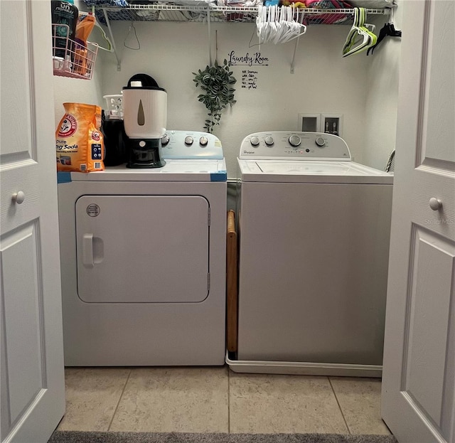 clothes washing area with laundry area, independent washer and dryer, and tile patterned flooring