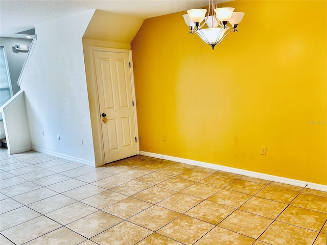 additional living space with light tile patterned floors and a chandelier