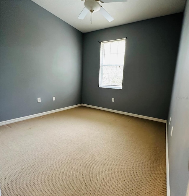 spare room with carpet floors and ceiling fan