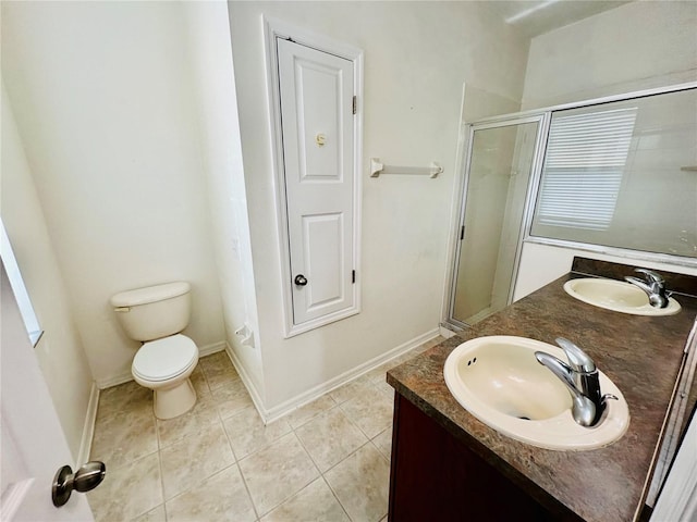 bathroom featuring vanity, toilet, a shower with shower door, and tile patterned flooring