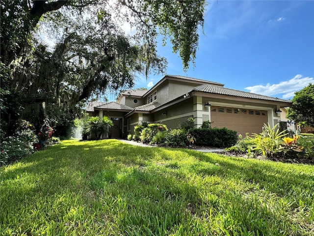 view of side of home with a tiled roof, a lawn, an attached garage, and stucco siding