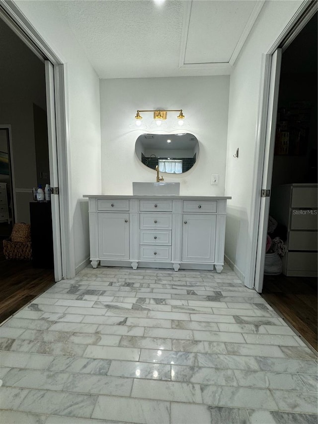 bathroom with vanity and a textured ceiling