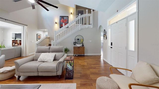 entrance foyer featuring ceiling fan, wood-type flooring, and high vaulted ceiling