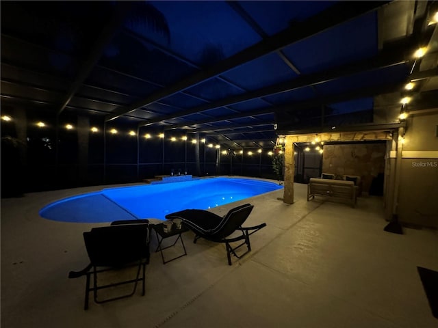 pool at twilight with a fenced in pool, a lanai, and a patio