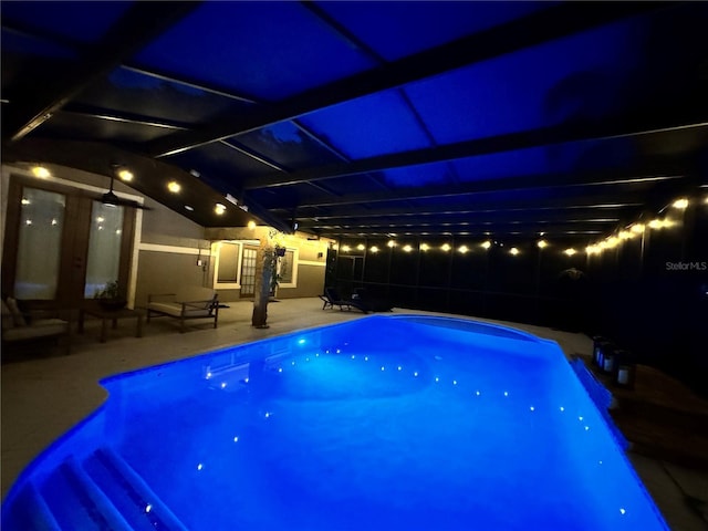 pool at twilight featuring a patio and a fenced in pool