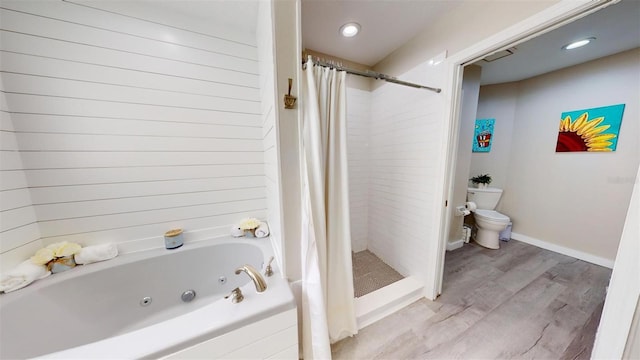 full bath featuring a stall shower, baseboards, toilet, a tub with jets, and wood finished floors