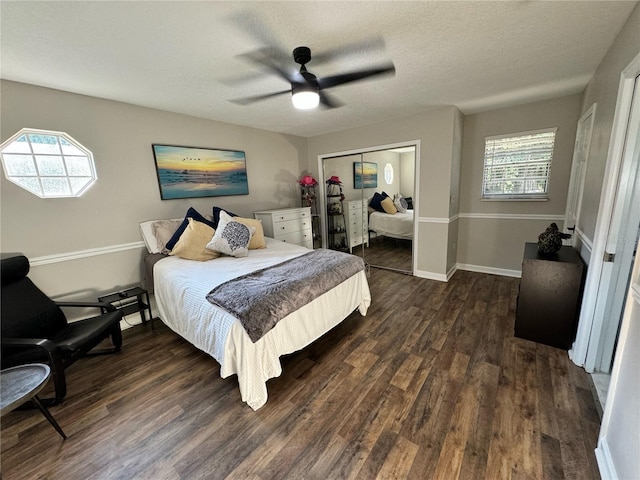 bedroom featuring a textured ceiling, dark hardwood / wood-style flooring, a closet, and ceiling fan