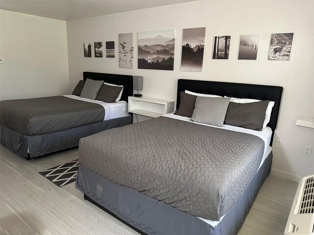 bedroom featuring wood finished floors and baseboards