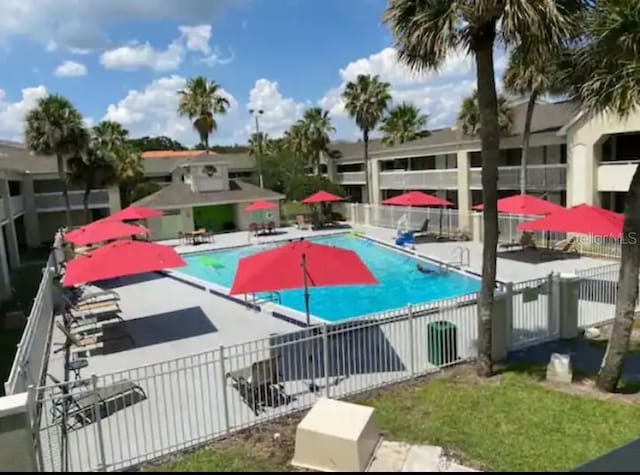 community pool featuring fence and a patio