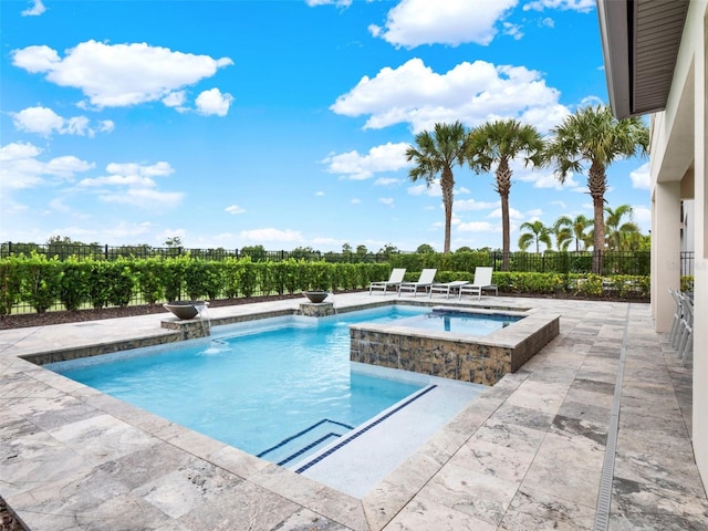 view of swimming pool with pool water feature, an in ground hot tub, and a patio