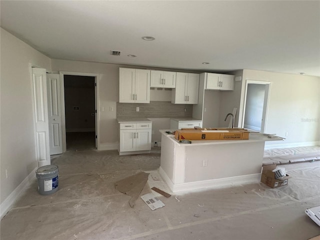 kitchen featuring white cabinets and a center island