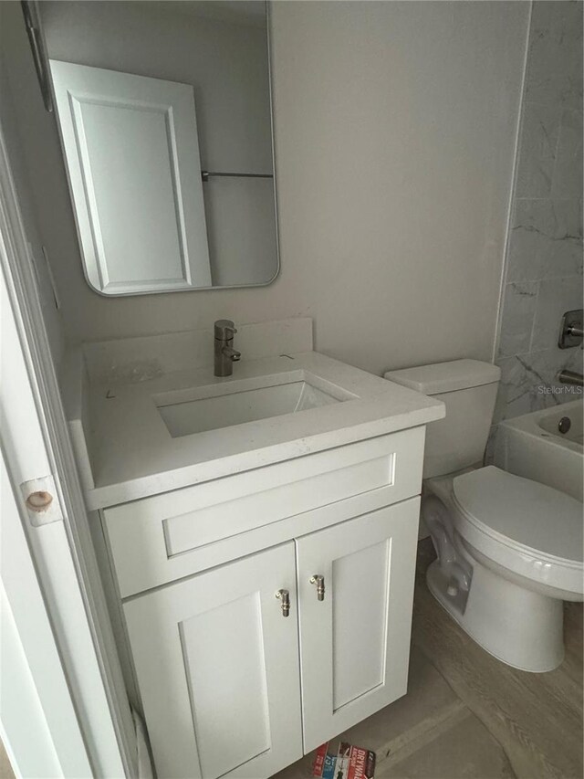 full bathroom with vanity, toilet,  shower combination, and tile patterned flooring