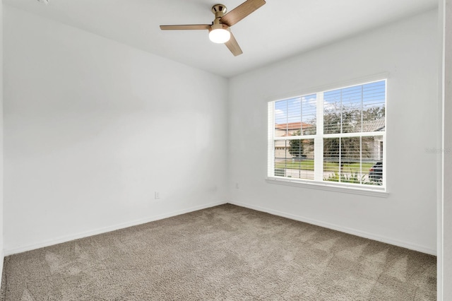 spare room featuring carpet floors and ceiling fan