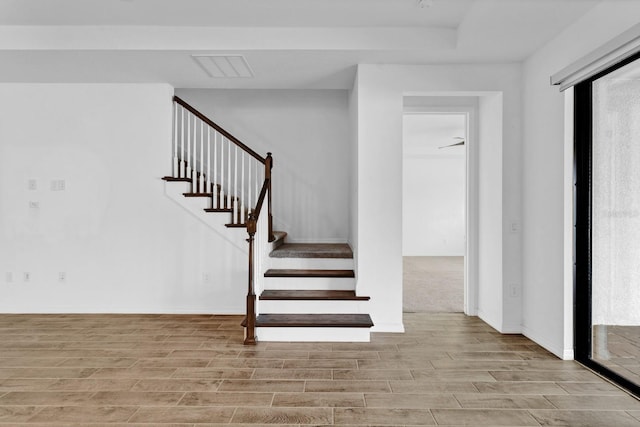 stairs featuring wood-type flooring