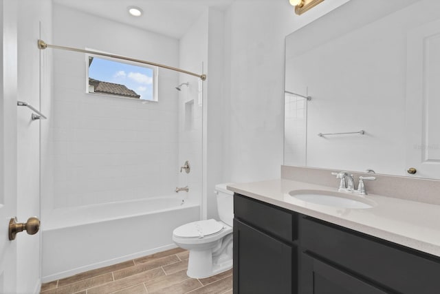 full bathroom with vanity, toilet, and tiled shower / bath