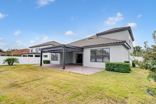 back of property with a patio and a yard