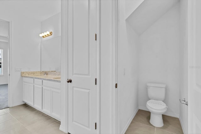 bathroom with vanity, tile patterned floors, and toilet