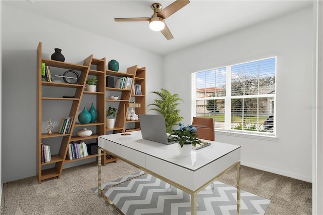 home office featuring light carpet and ceiling fan