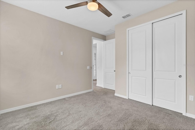 unfurnished bedroom with carpet flooring, ceiling fan, and a closet