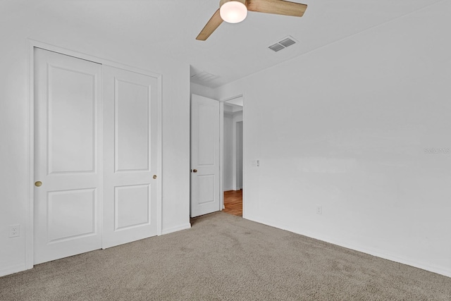 unfurnished bedroom featuring ceiling fan, carpet floors, and a closet