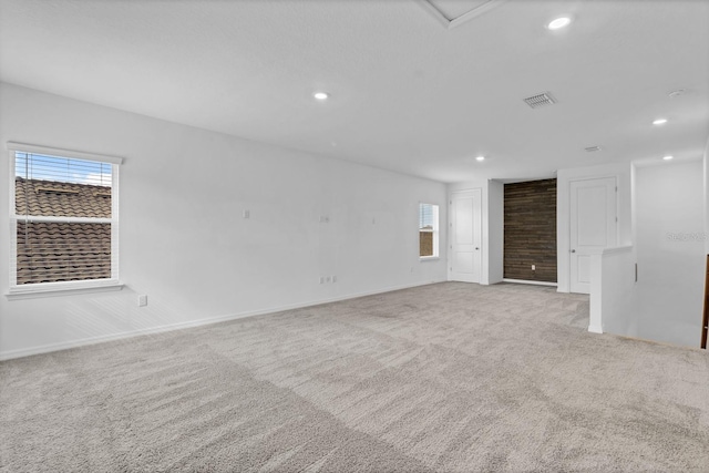 unfurnished room with light carpet and a wealth of natural light