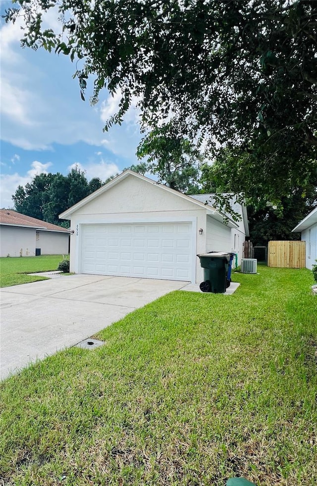 view of front facade with a garage, a front lawn, and cooling unit