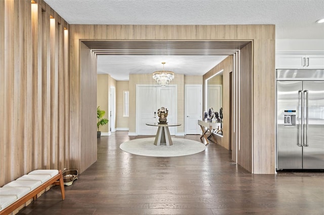 interior space featuring a textured ceiling, an inviting chandelier, and wood-type flooring