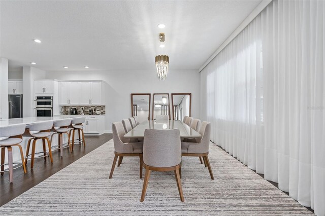 dining space featuring dark hardwood / wood-style flooring and a chandelier