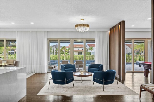 interior space with a textured ceiling, dark hardwood / wood-style floors, and a healthy amount of sunlight