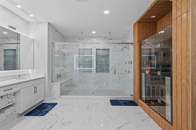 bathroom with tile patterned floors, a textured ceiling, vanity, and walk in shower