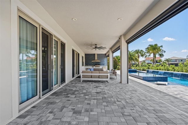 view of patio with ceiling fan, outdoor lounge area, and pool water feature