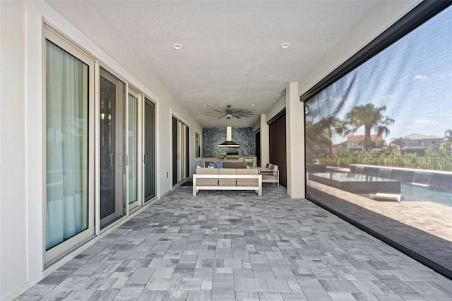 view of patio featuring an outdoor living space, pool water feature, and ceiling fan