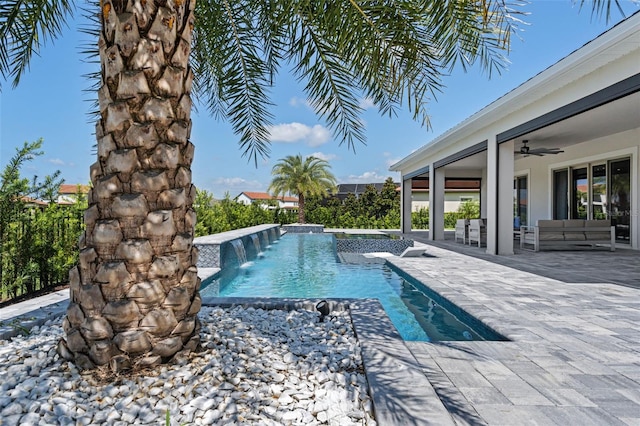 view of swimming pool with a jacuzzi, pool water feature, an outdoor hangout area, ceiling fan, and a patio area