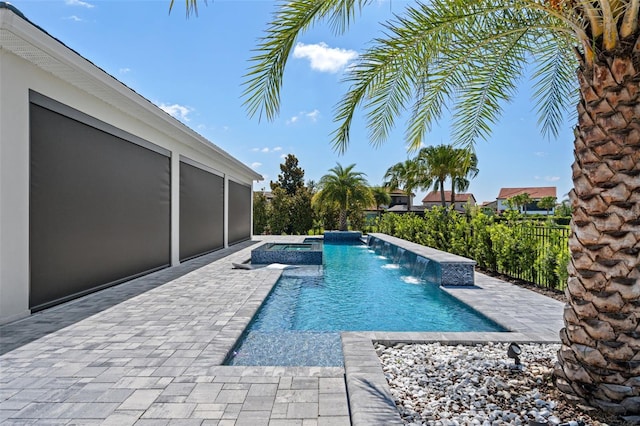 view of swimming pool featuring a jacuzzi, a patio area, and pool water feature