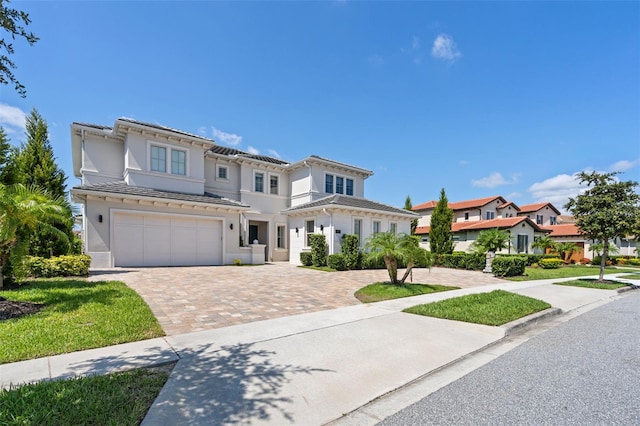 mediterranean / spanish house with a garage and a front yard