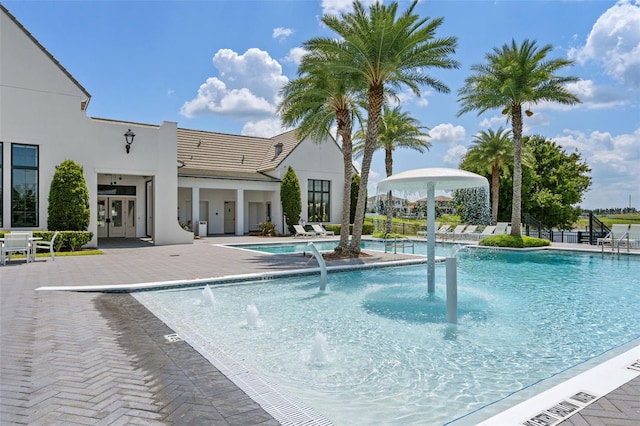 view of swimming pool with a patio and pool water feature