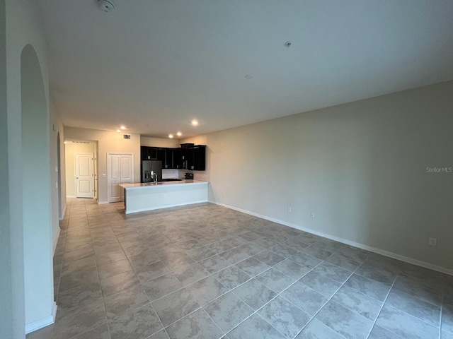 unfurnished living room featuring light tile patterned floors