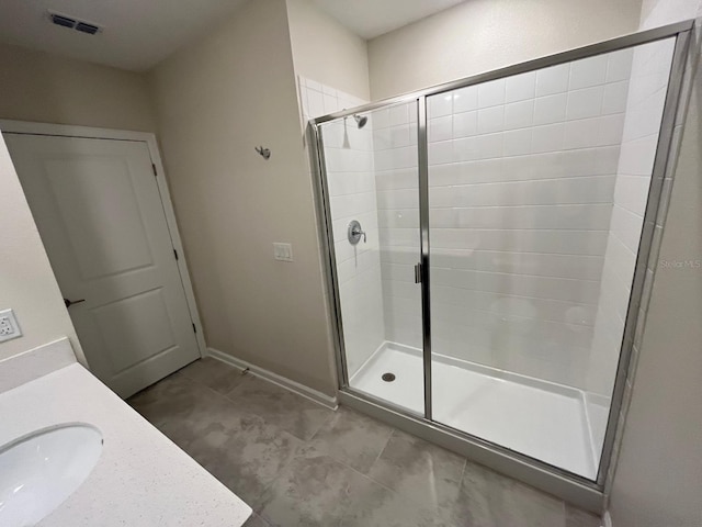 bathroom featuring an enclosed shower, tile patterned floors, and sink