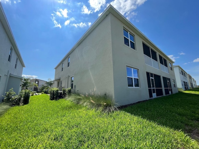 rear view of house featuring a lawn