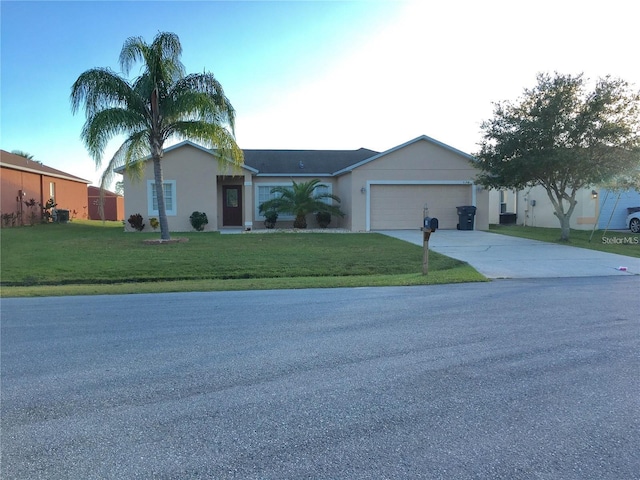 single story home featuring a garage and a front yard