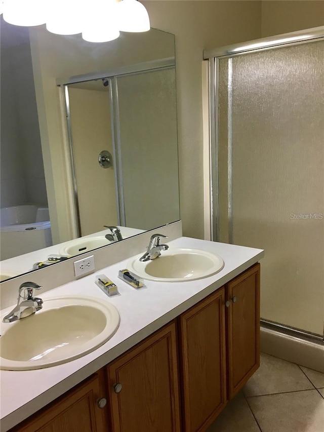 bathroom with shower with separate bathtub, vanity, and tile patterned floors