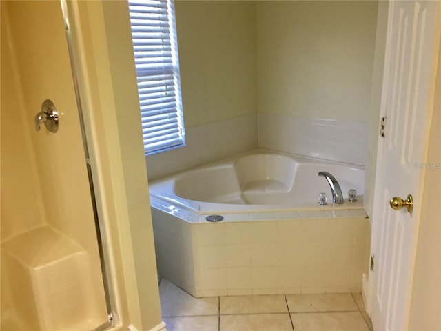 bathroom featuring tile patterned flooring and shower with separate bathtub