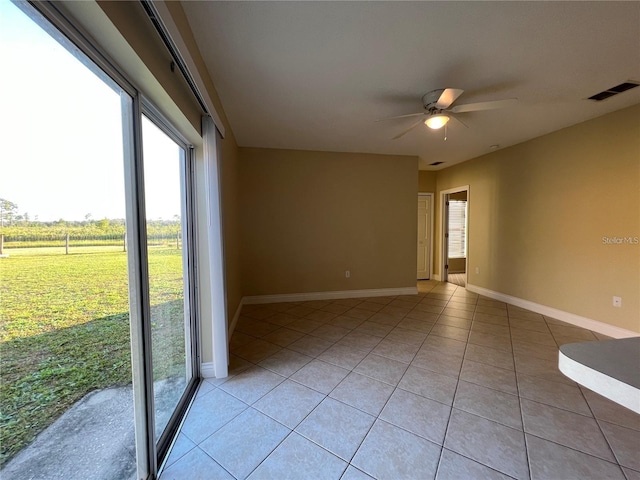 empty room featuring ceiling fan and light tile patterned floors