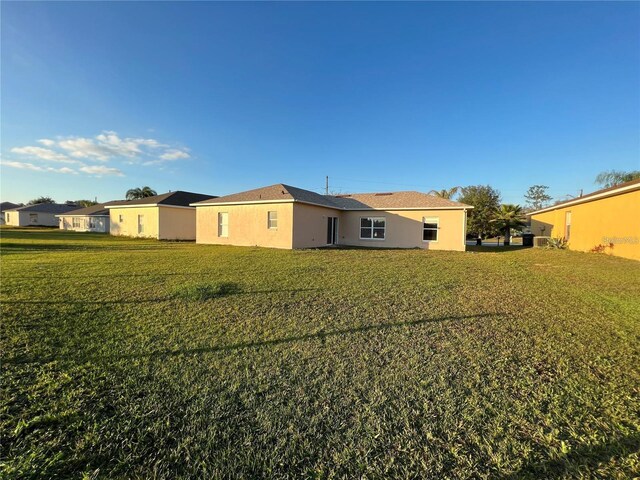 back of property with a lawn