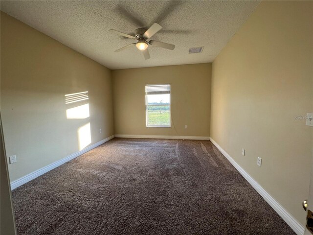 unfurnished room featuring ceiling fan, carpet floors, and a textured ceiling