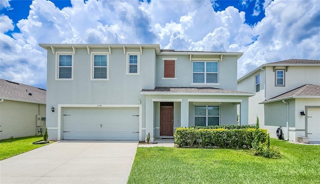 view of front of home featuring a front yard and a garage