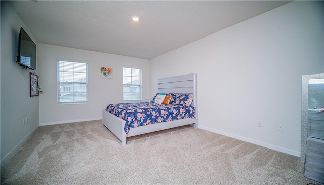 carpeted bedroom featuring baseboards and a textured ceiling