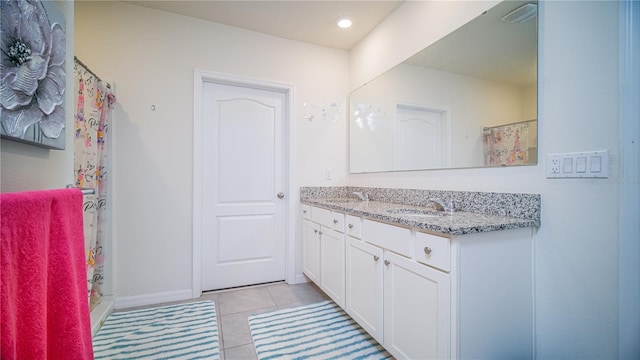 full bath featuring a sink, double vanity, curtained shower, and tile patterned flooring