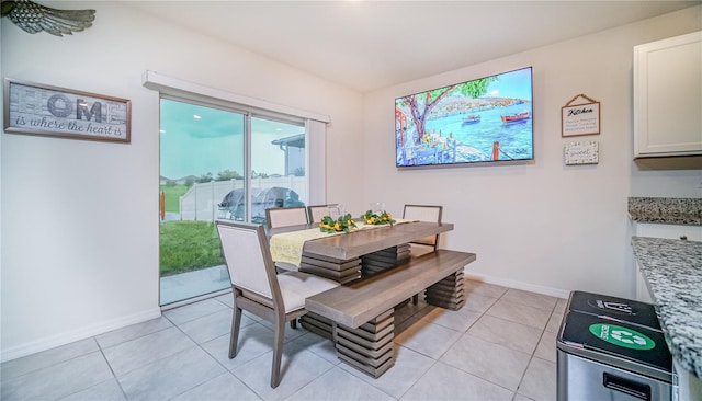 dining area featuring baseboards and light tile patterned flooring