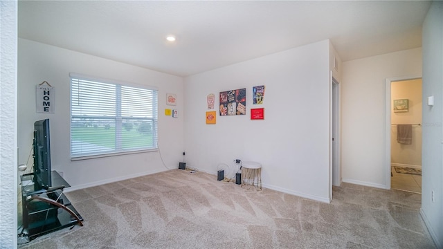 empty room with baseboards and light colored carpet